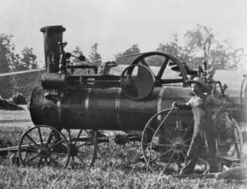 W-016 - Walter Steam Tractor - Uncle John beside wheel.jpg